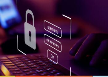 Pessoa digitando em laptop com ícone de cadeado e campos de login projetados na tela, simbolizando segurança digital para evitar vagas falsas e proteger dados em processos seletivos.